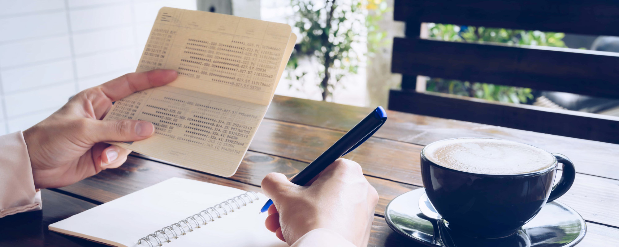 Someone hands holding saving account passbook. Passbook is a copy of the account of the customer as it appears in the banks book