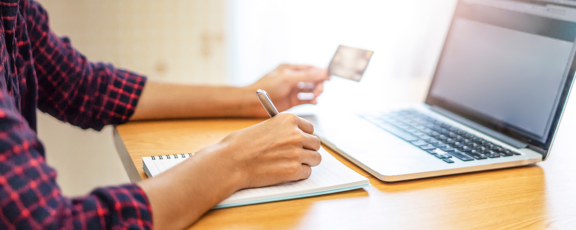 closeup of hands with a laptop computer using it to browsing through ecommerce