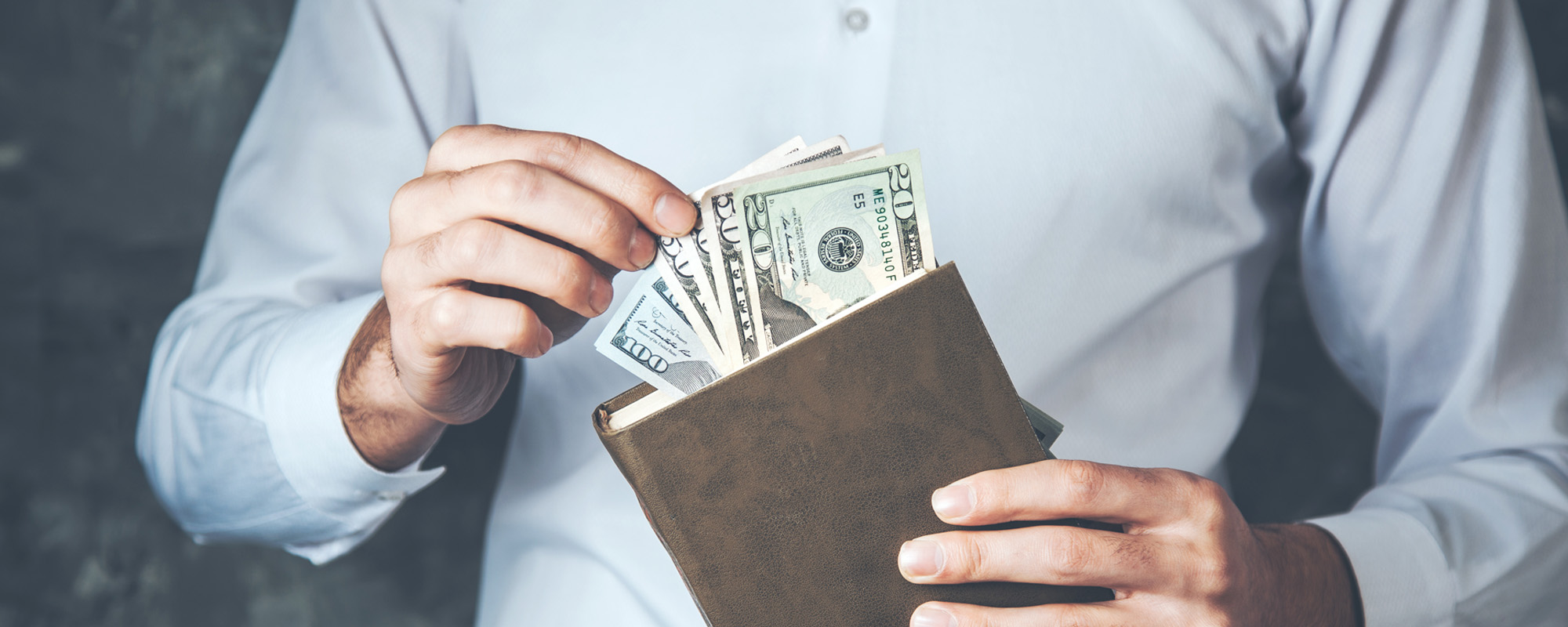 man holding money on the book