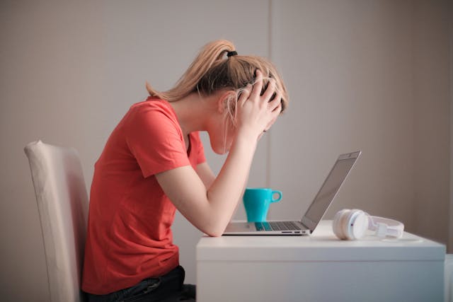 stressed woman at a computer
