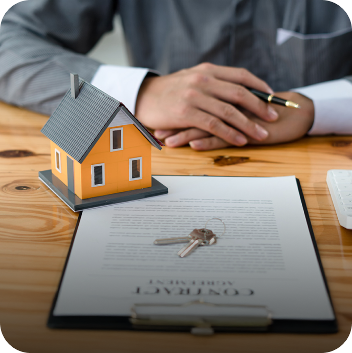 person sitting at a desk with a mortgage in front of them