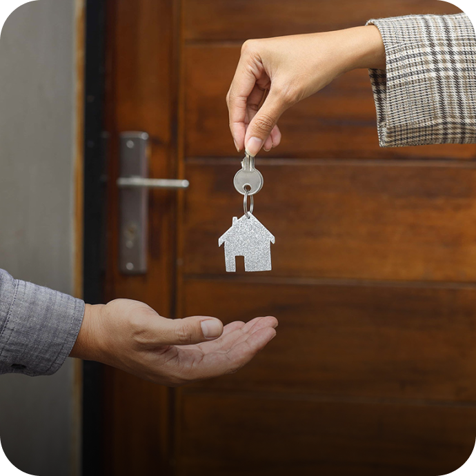 real estate agent handing someone keys to a house