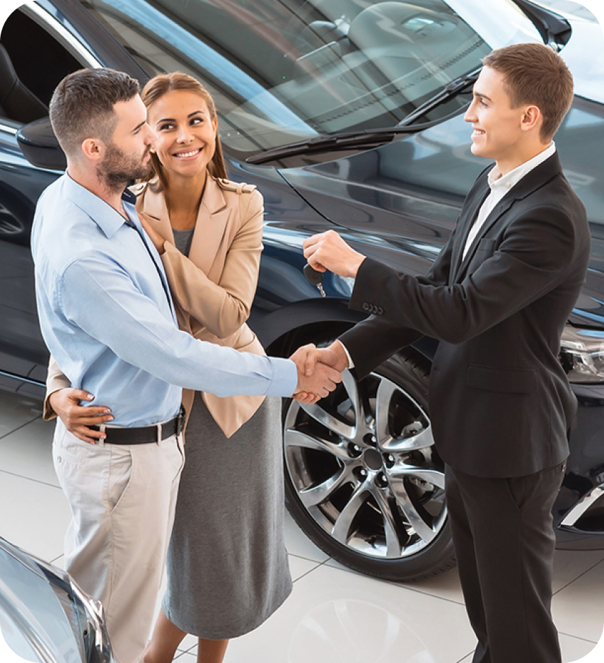 man and woman speaking to a car salesman
